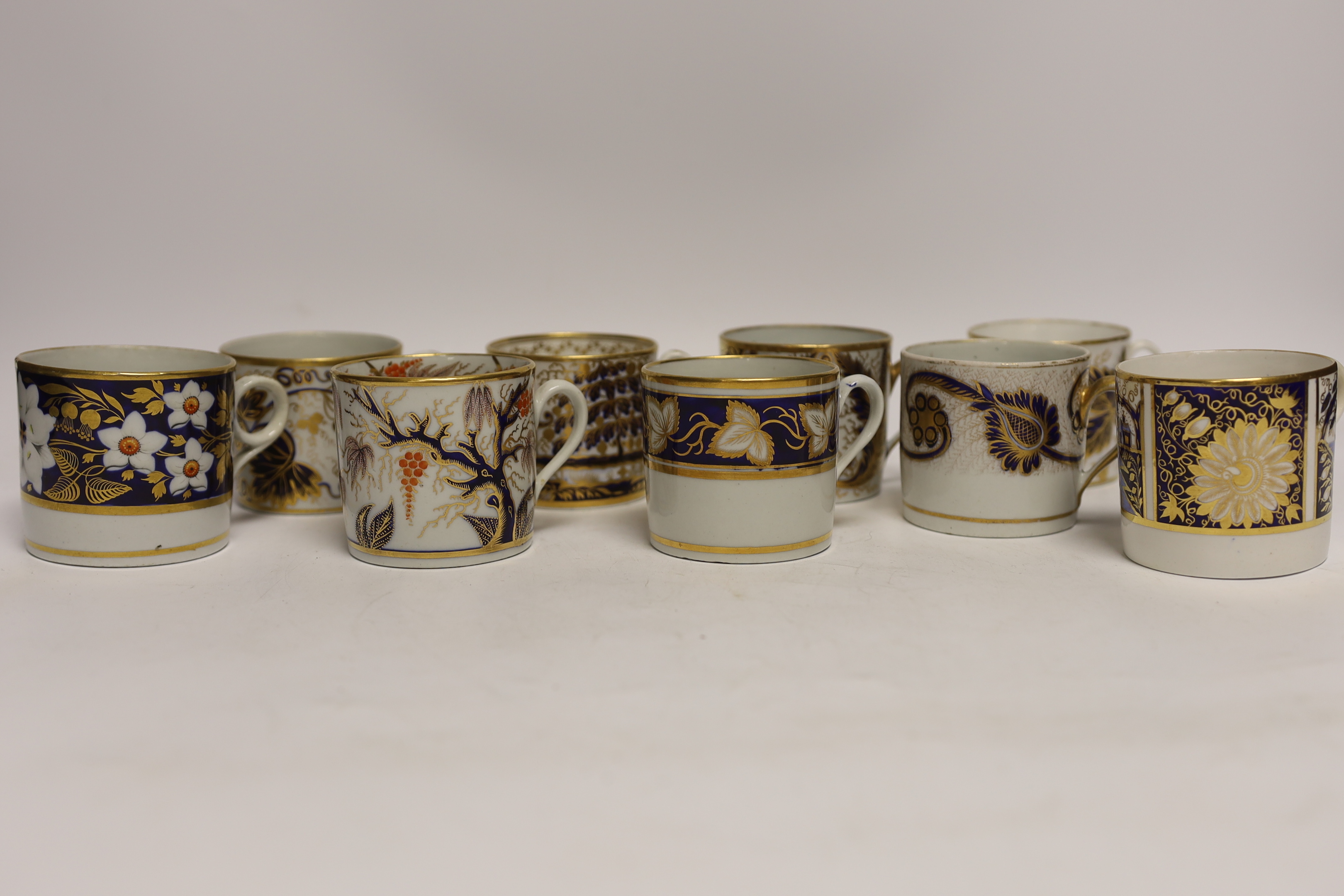 Twelve 1800-1820 English porcelain, mostly blue and gilt decorated coffee cans